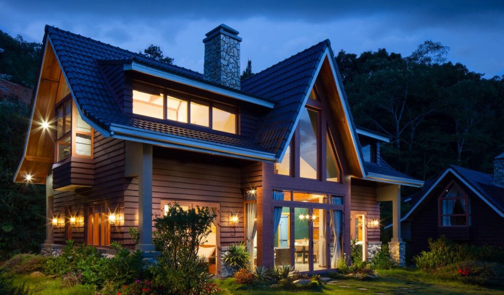 Exterior of a home at night illuminated by lighting features